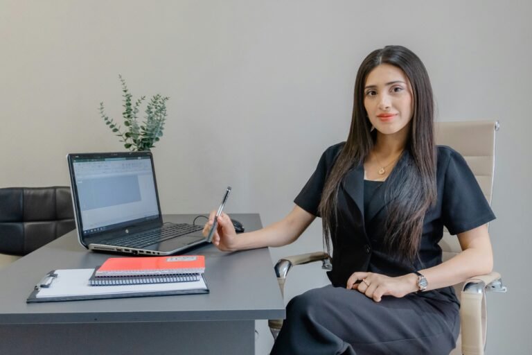 How Women in India Can Build P&L Experience for Leadership Roles Woman professional reviewing business documents and a laptop at her desk